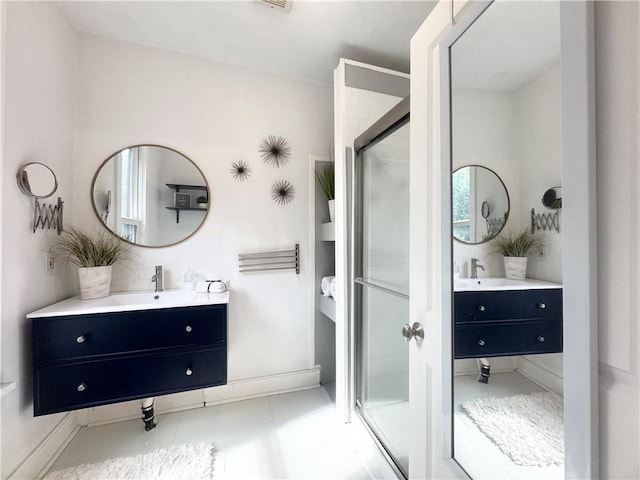 1643 Jefferson St, Kansas City, MO 64108 - full bath featuring a shower stall, two vanities, and tile patterned floors