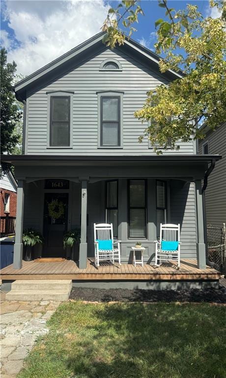 1643 Jefferson St, Kansas City, MO 64108 - view of front of property with covered porch and a front yard