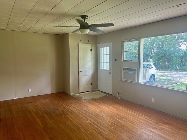 3107 Wood Ave, Parsons, KS 67357 - spare room with wood-type flooring, ceiling fan, and cooling unit