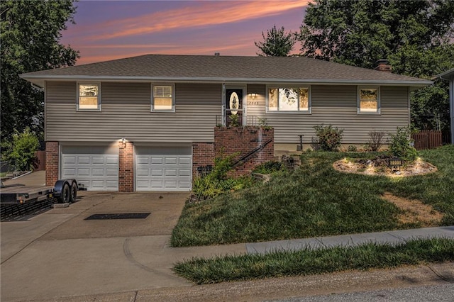 2005 Manor Pl, Blue Springs, MO 64015 - view of front of house featuring driveway, an attached garage, a chimney, and brick siding