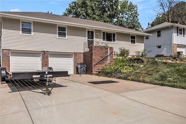2005 Manor Pl, Blue Springs, MO 64015 - view of front facade featuring concrete driveway, brick siding, an attached garage, and a front lawn