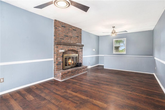 2005 Manor Pl, Blue Springs, MO 64015 - unfurnished living room featuring ceiling fan, wood finished floors, and a brick fireplace