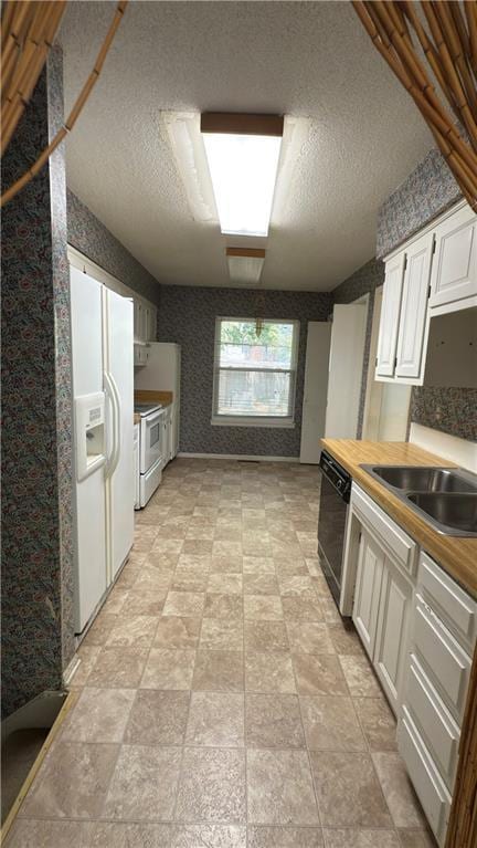 11965 W 66th St, Shawnee, KS 66216 - kitchen with dishwasher, white fridge with ice dispenser, stove, wallpapered walls, and white cabinets