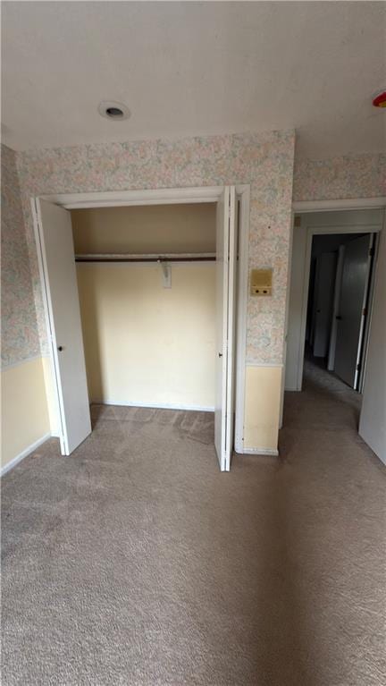 11965 W 66th St, Shawnee, KS 66216 - unfurnished bedroom featuring wallpapered walls, carpet floors, and a closet