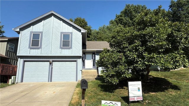 11965 W 66th St, Shawnee, KS 66216 - split level home featuring an attached garage, driveway, and a front lawn