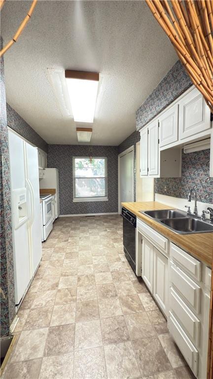 11965 W 66th St, Shawnee, KS 66216 - kitchen with white appliances, white cabinets, wallpapered walls, a textured ceiling, and butcher block counters