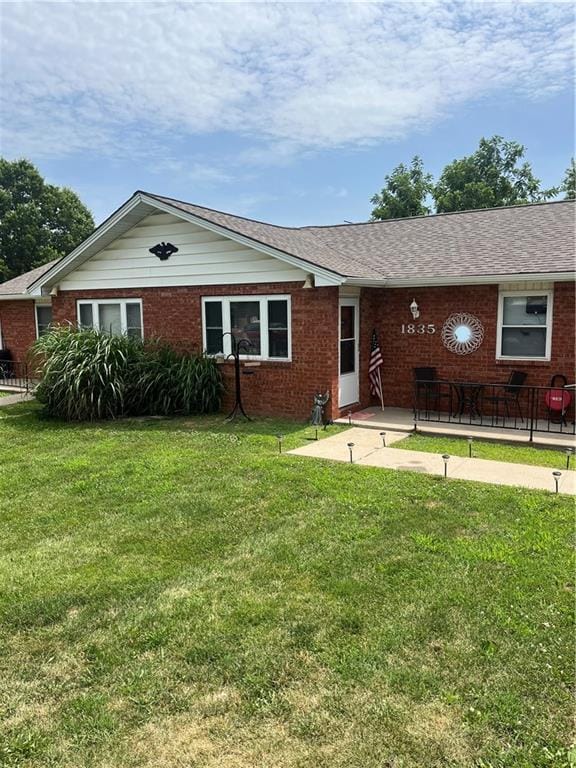 1835-1837 N 77th St, Kansas City, KS 66112 - ranch-style house featuring brick siding, a front yard, and a patio area