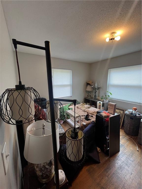 1835-1837 N 77th St, Kansas City, KS 66112 - dining room featuring wood finished floors and a textured ceiling