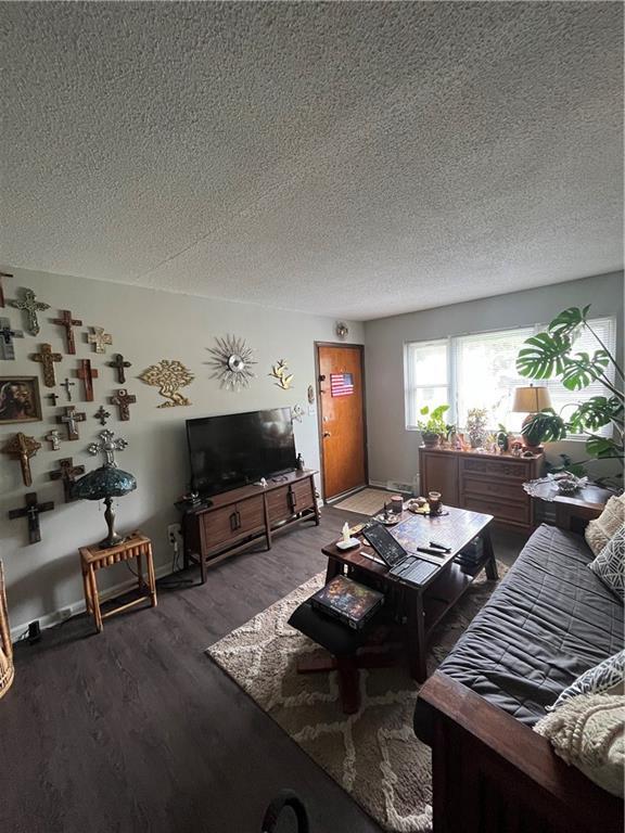 1835-1837 N 77th St, Kansas City, KS 66112 - living room with wood finished floors and a textured ceiling