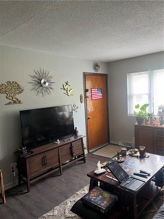 1835-1837 N 77th St, Kansas City, KS 66112 - living area featuring wood finished floors and a textured ceiling