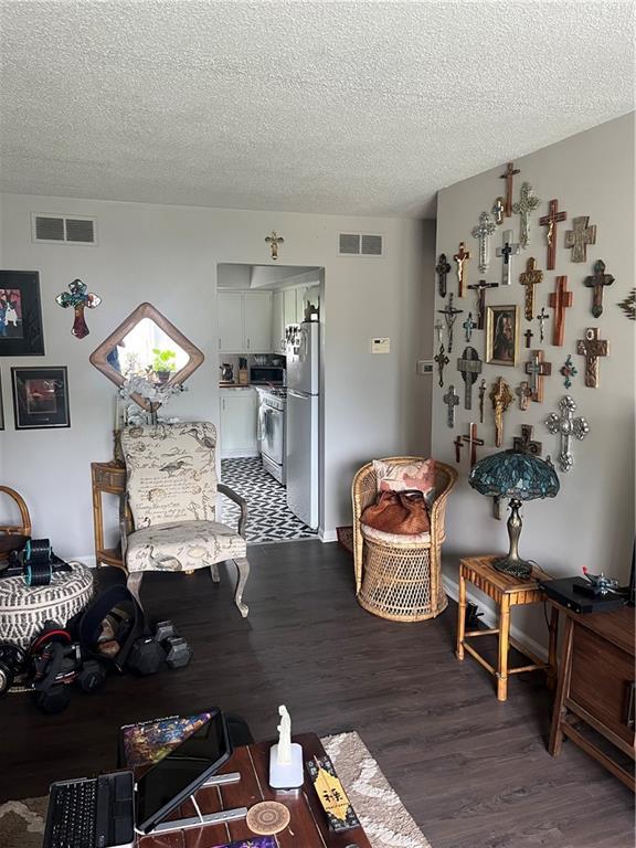 1835-1837 N 77th St, Kansas City, KS 66112 - living area featuring wood finished floors and a textured ceiling