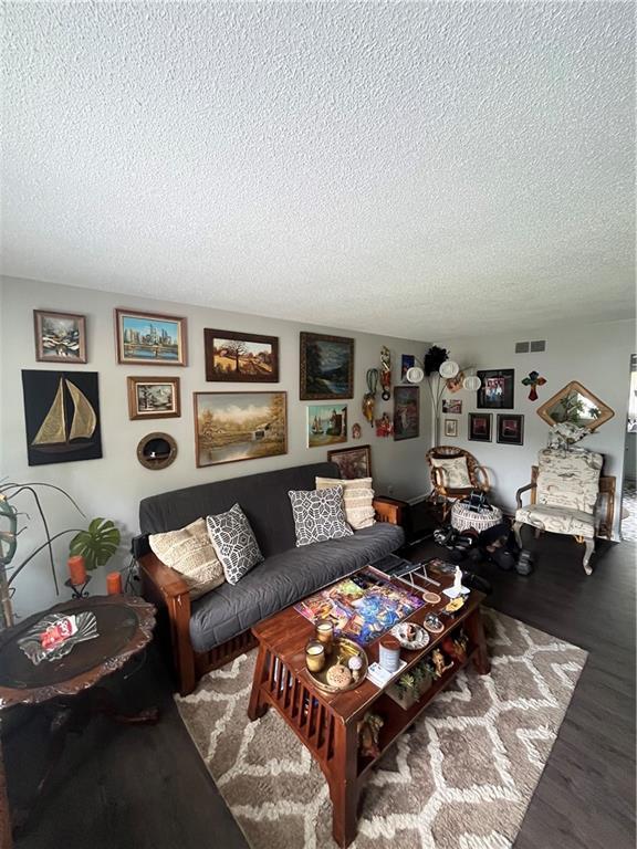 1835-1837 N 77th St, Kansas City, KS 66112 - living room featuring a textured ceiling and wood finished floors