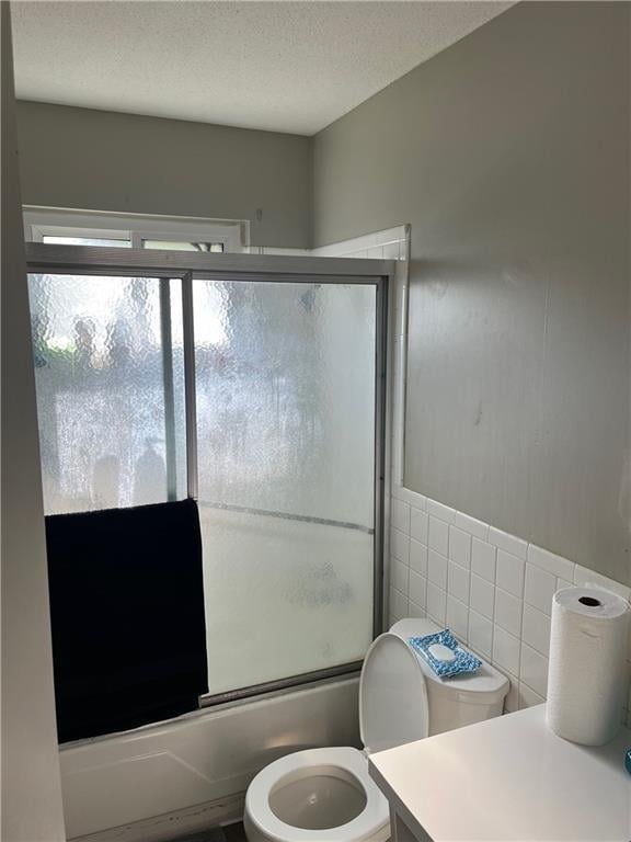 1835-1837 N 77th St, Kansas City, KS 66112 - full bath with tile walls, combined bath / shower with glass door, and vanity