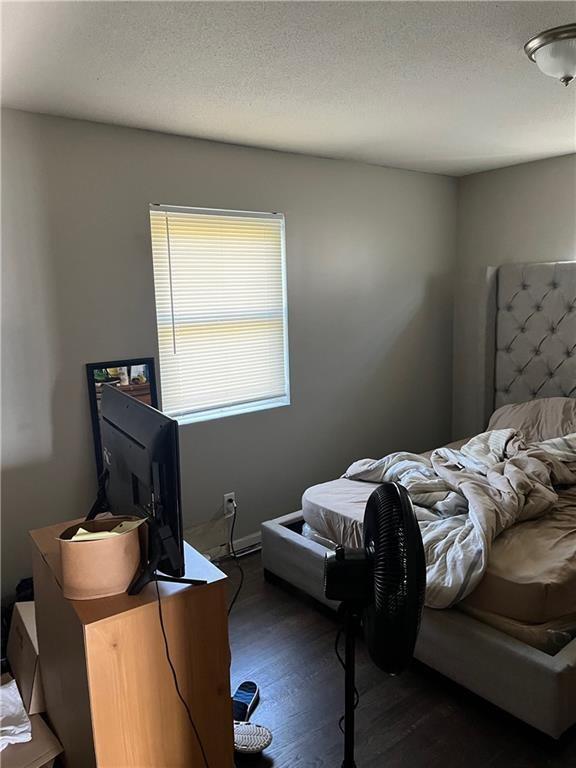 1835-1837 N 77th St, Kansas City, KS 66112 - bedroom with dark wood-style floors and a textured ceiling