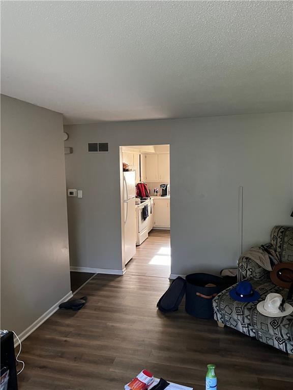 1835-1837 N 77th St, Kansas City, KS 66112 - living room with light wood finished floors and a textured ceiling