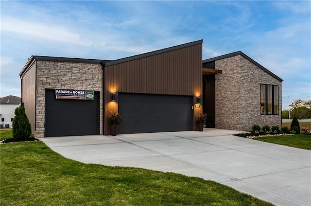 18221 W 168th Ter, Olathe, KS 66062 - contemporary house featuring stone siding, a garage, driveway, and a front yard