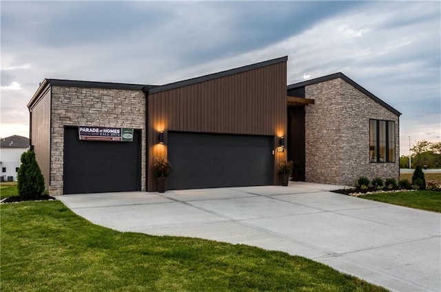 18221 W 168th Ter, Olathe, KS 66062 - contemporary home with stone siding, a garage, concrete driveway, and a front lawn