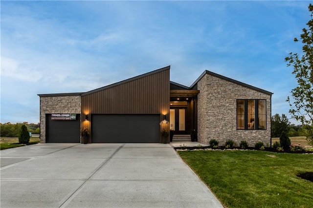 18221 W 168th Ter, Olathe, KS 66062 - modern home featuring stone siding, a garage, and driveway