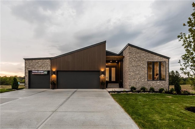 18221 W 168th Ter, Olathe, KS 66062 - contemporary home featuring stone siding, a garage, and concrete driveway