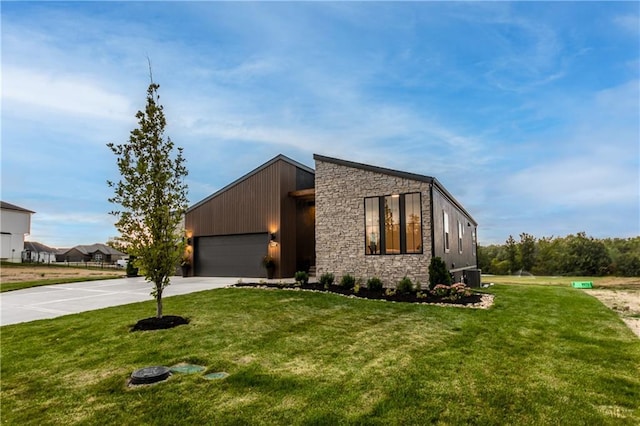 18221 W 168th Ter, Olathe, KS 66062 - contemporary home with driveway, stone siding, a front lawn, and a garage