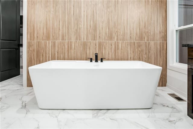 18221 W 168th Ter, Olathe, KS 66062 - bathroom with marble finish flooring, a freestanding tub, and tile walls