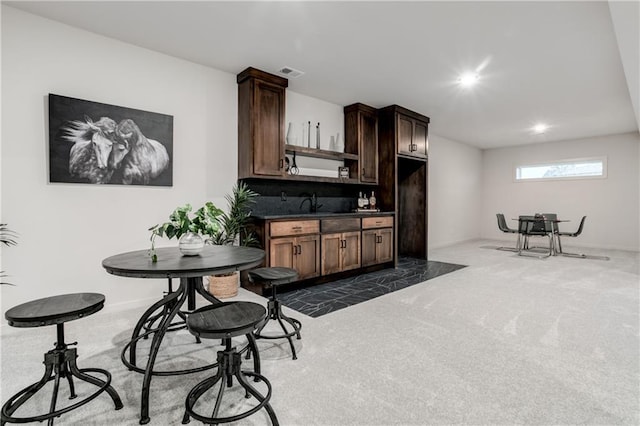 18221 W 168th Ter, Olathe, KS 66062 - kitchen featuring open shelves, dark countertops, dark colored carpet, recessed lighting, and dark brown cabinetry