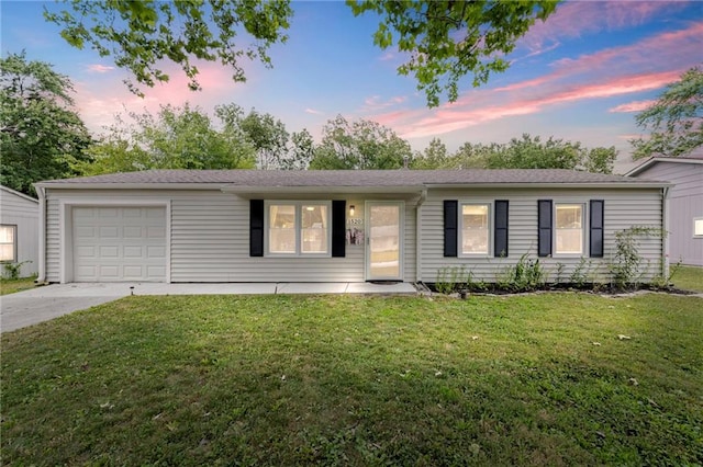 1520 E 18th St, Lawrence, KS 66044 - ranch-style home featuring an attached garage, concrete driveway, and a front yard