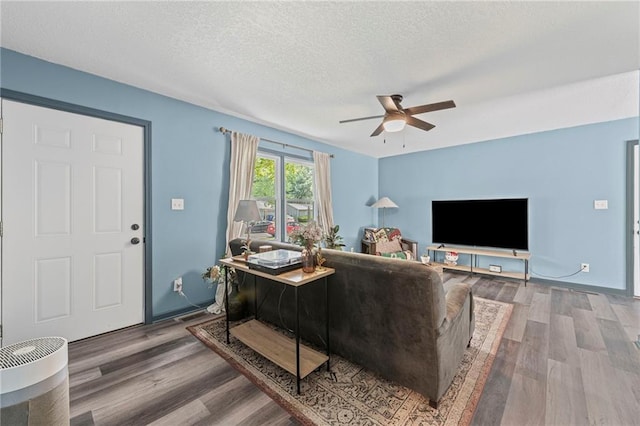 1520 E 18th St, Lawrence, KS 66044 - living area featuring ceiling fan, wood finished floors, and a textured ceiling