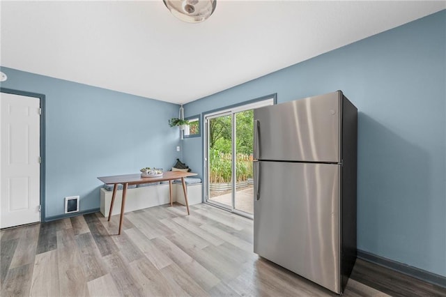 1520 E 18th St, Lawrence, KS 66044 - kitchen with freestanding refrigerator and wood finished floors
