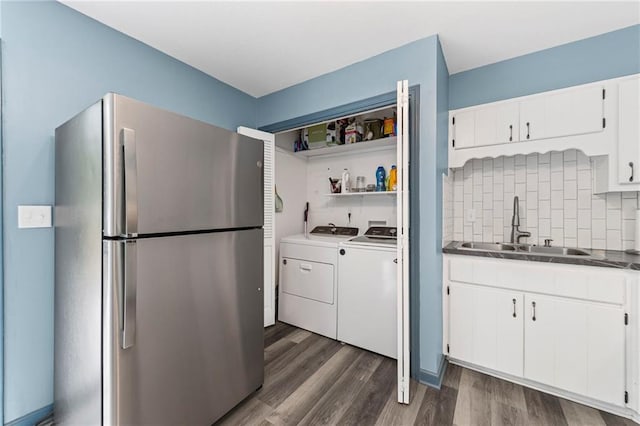 1520 E 18th St, Lawrence, KS 66044 - kitchen featuring freestanding refrigerator, washing machine and clothes dryer, dark wood finished floors, tasteful backsplash, and white cabinetry