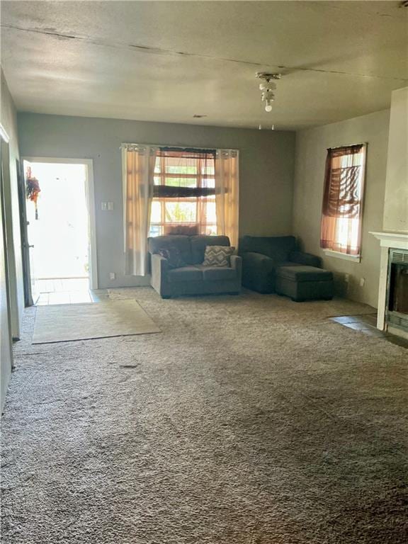 308 S 16th St, Independence, KS 67301 - carpeted living area with plenty of natural light and a fireplace with flush hearth