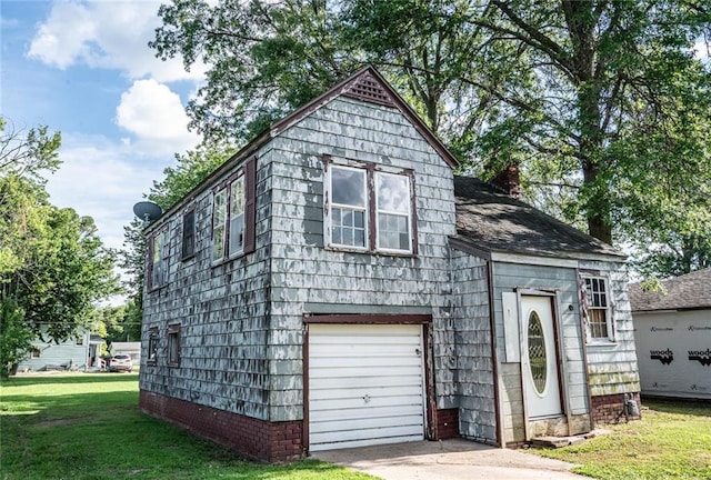 615 Mill St, Neodesha, KS 66757 - view of front of home with a front yard, a garage, and a chimney