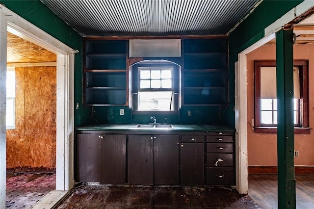 615 Mill St, Neodesha, KS 66757 - kitchen with open shelves, dark brown cabinetry, and built in shelves