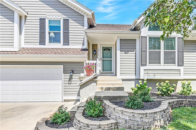16113 S Cole St, Olathe, KS 66062 - doorway to property featuring driveway, a shingled roof, and a garage