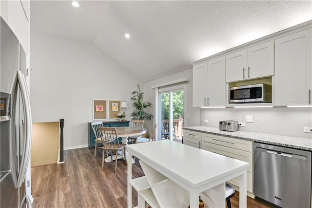 16113 S Cole St, Olathe, KS 66062 - kitchen with stainless steel appliances, dark wood finished floors, recessed lighting, a breakfast bar area, and light stone counters