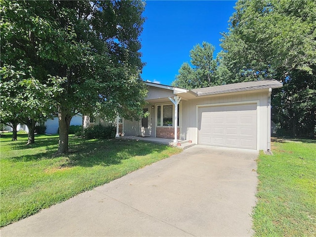 414 N Ash St, Garnett, KS 66032 - view of front of property with an attached garage, driveway, and a front lawn