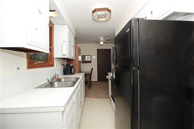 414 N Ash St, Garnett, KS 66032 - kitchen with freestanding refrigerator, ceiling fan, white cabinetry, and light countertops