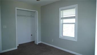 5007 Euclid Ave, Kansas City, MO 64130 - unfurnished bedroom featuring multiple windows and a closet