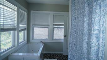 5007 Euclid Ave, Kansas City, MO 64130 - full bathroom featuring a whirlpool tub