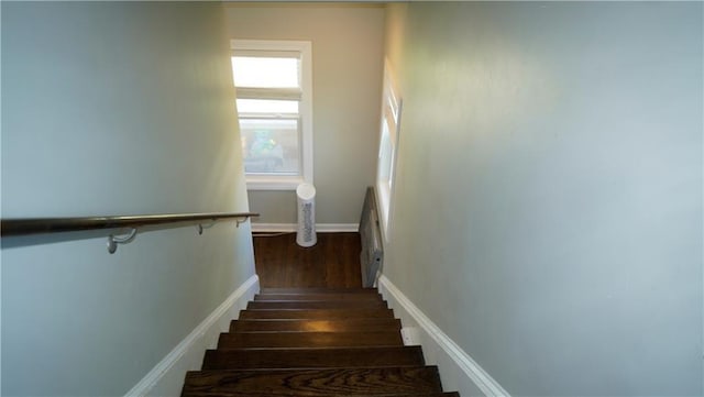 5007 Euclid Ave, Kansas City, MO 64130 - staircase featuring wood finished floors and baseboards