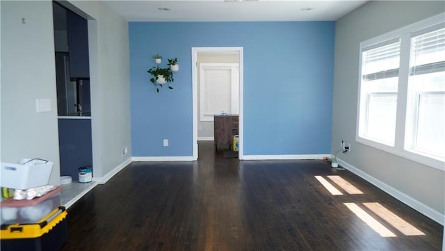 5007 Euclid Ave, Kansas City, MO 64130 - unfurnished room featuring wood finished floors and baseboards