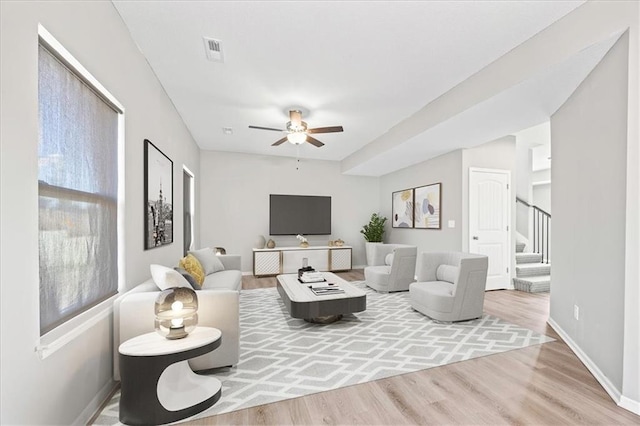 2814 N 100th St, Kansas City, KS 66109 - living area featuring a ceiling fan, wood finished floors, and stairway