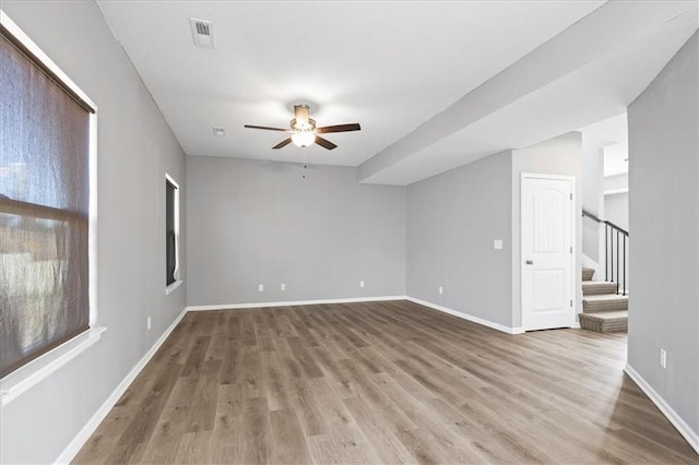 2814 N 100th St, Kansas City, KS 66109 - unfurnished room featuring a ceiling fan, wood finished floors, and stairs