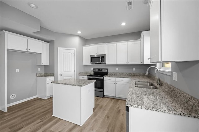 2814 N 100th St, Kansas City, KS 66109 - kitchen with appliances with stainless steel finishes, light stone countertops, white cabinets, and recessed lighting