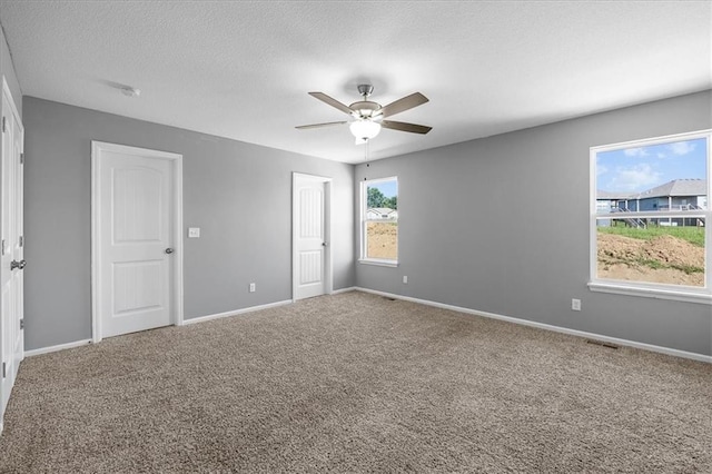 2814 N 100th St, Kansas City, KS 66109 - unfurnished bedroom with carpet, ceiling fan, a textured ceiling, and a closet