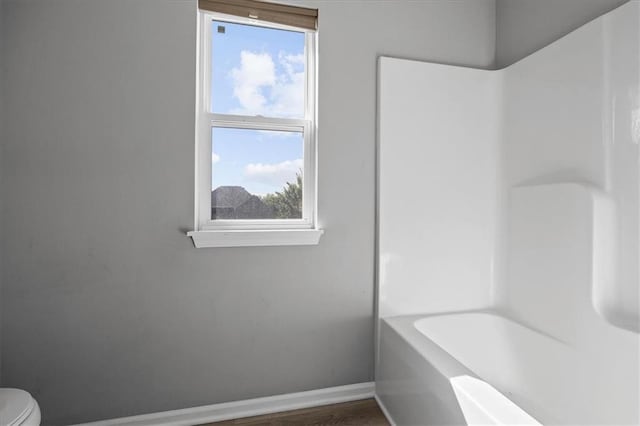 2814 N 100th St, Kansas City, KS 66109 - bathroom featuring wood finished floors and washtub / shower combination