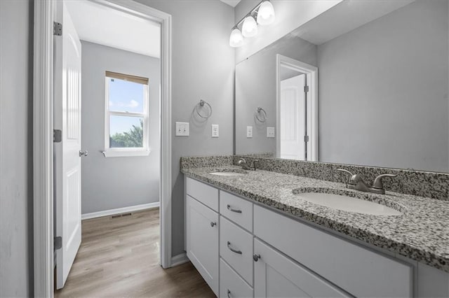 2814 N 100th St, Kansas City, KS 66109 - bathroom with double vanity and wood finished floors