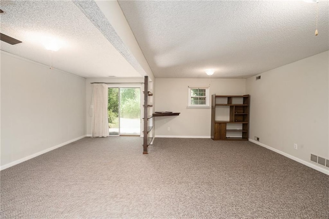 2618 Manor Ter, Lawrence, KS 66046 - unfurnished living room with a textured ceiling, carpet floors, and ceiling fan