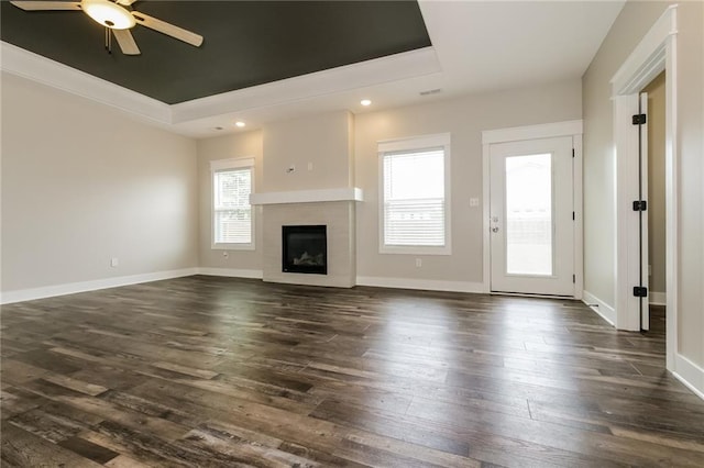 15904 E Cogan Ln, Independence, MO 64050 - unfurnished living room with a tray ceiling, ceiling fan, dark wood-style floors, and recessed lighting