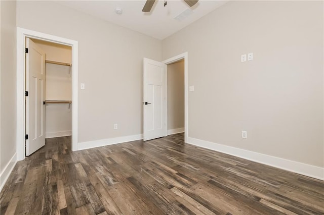 15904 E Cogan Ln, Independence, MO 64050 - unfurnished bedroom featuring dark wood finished floors, a walk in closet, and a ceiling fan